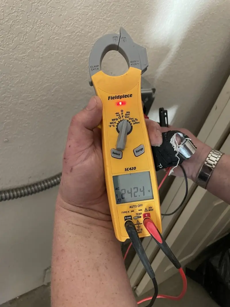 Voltage testing with clamp meter during Whole House Surge Protector in Winston